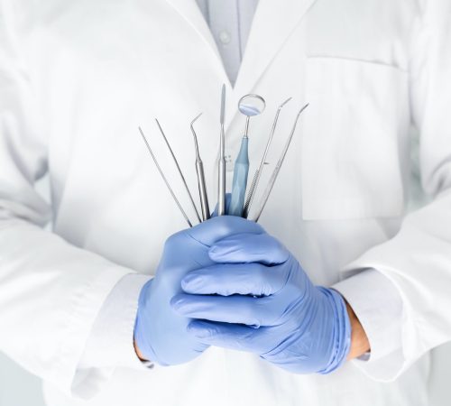 close-up-of-dentist-hands-with-dental-equipment.jpg